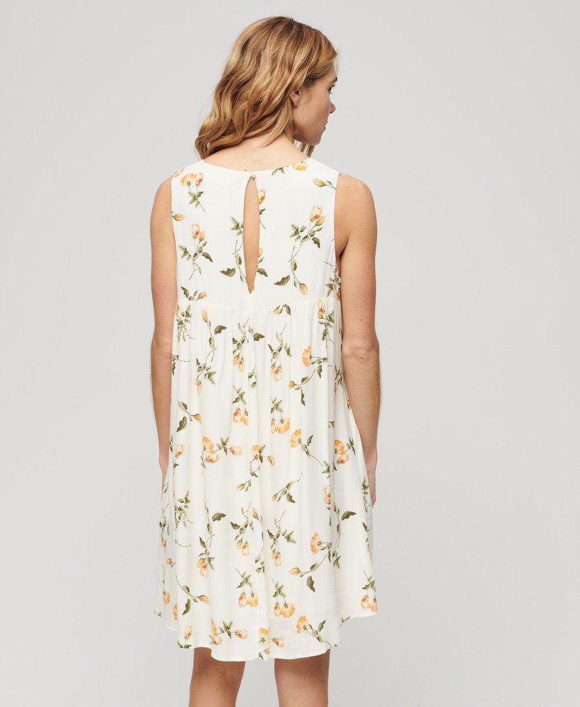 mouwloze jurk met volumineuze print in perzikroze.