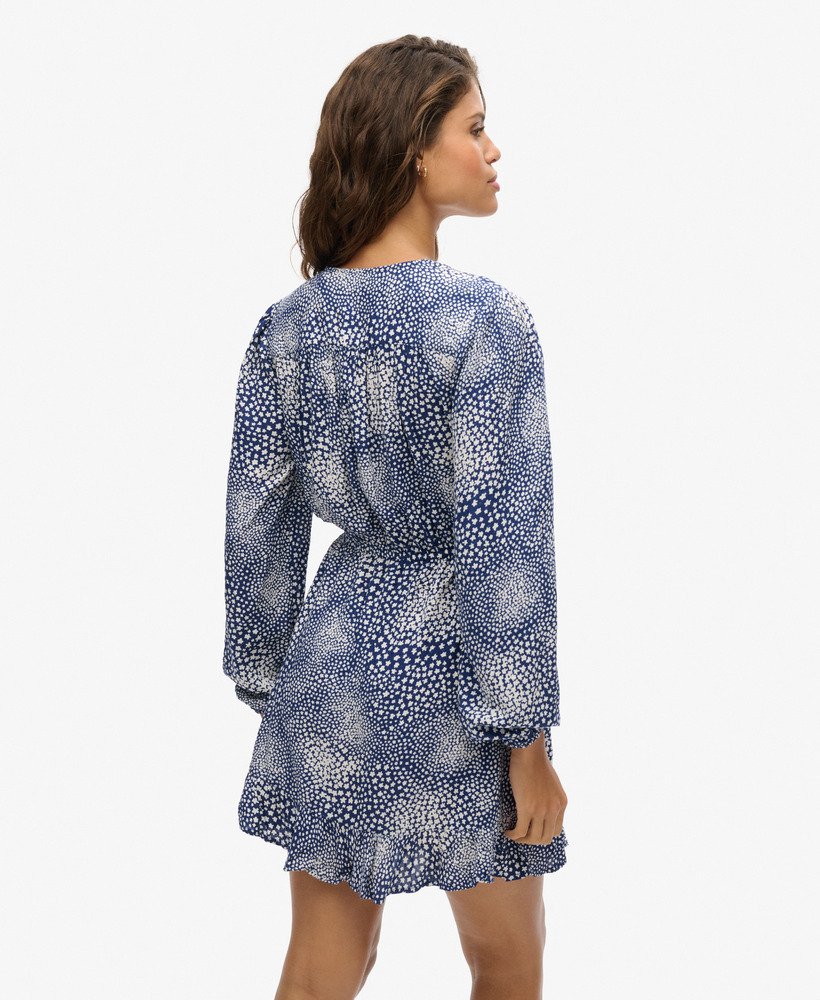 bedrukte mini-jurk met lange mouwen en overslagprint in een donkerblauwe kleur met verspreide stippen.