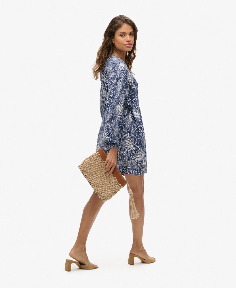 bedrukte mini-jurk met lange mouwen en overslagprint in een donkerblauwe kleur met verspreide stippen.