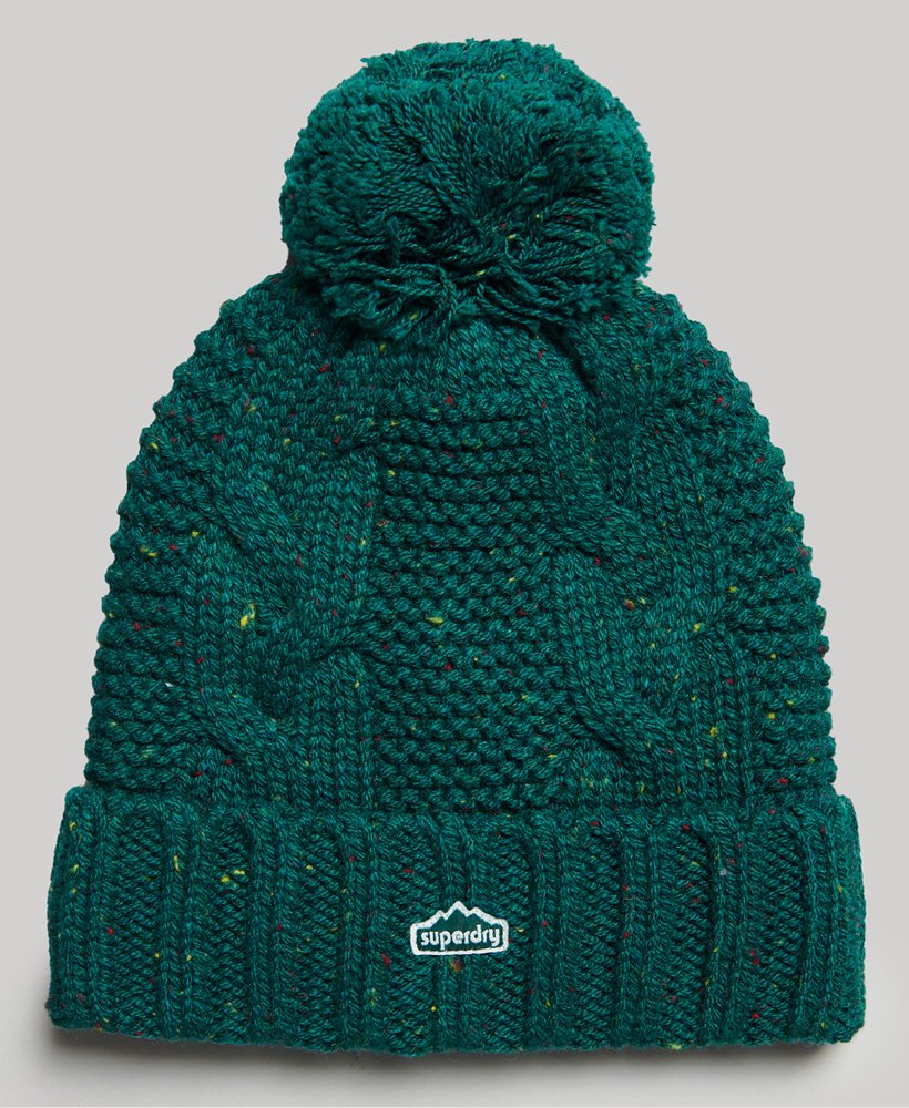 kabelgebreide muts met pompon in bosgroene tweed