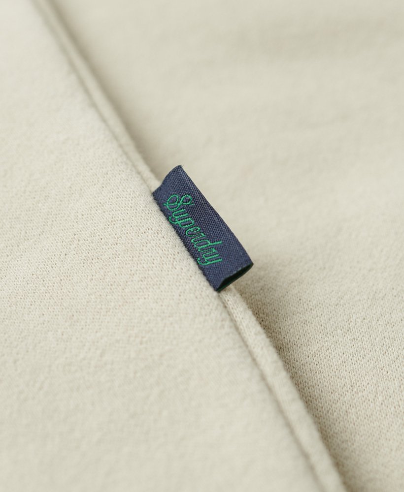 essential logo zip track top in light stone beige