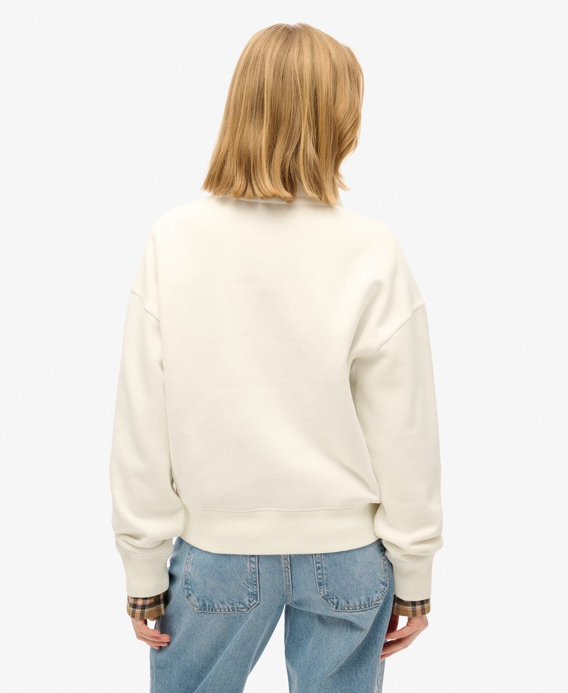 essentiële half-zip sweater in gebroken wit.