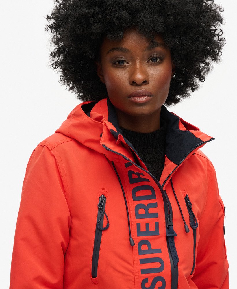 capuchonjack ultimate sd-windcheater in opvallend oranjediepblauw