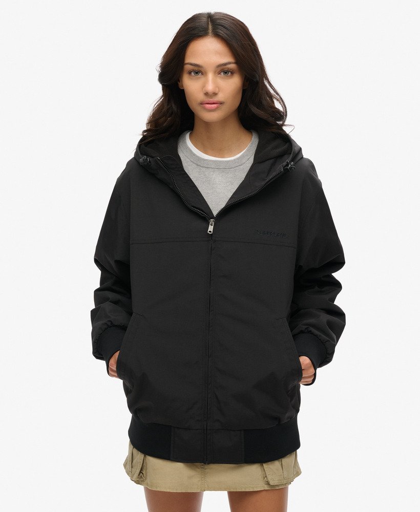 oversized bomberjack met capuchon van overtollig nylon in gitzwart.