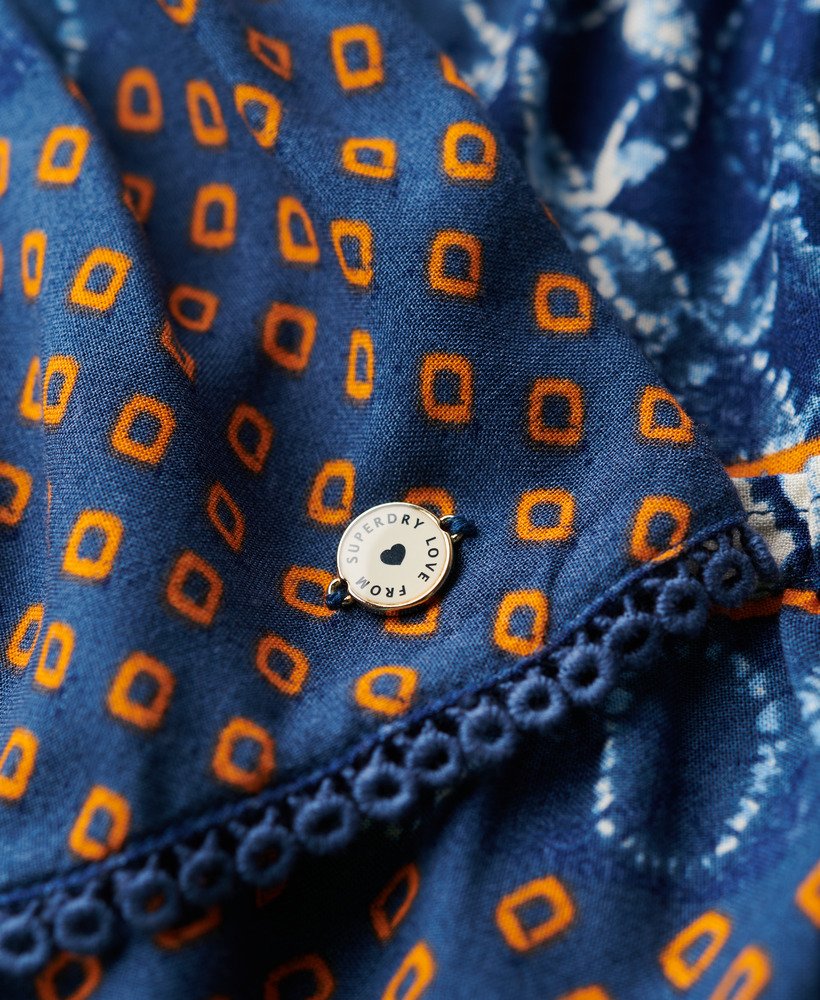 bedrukte geplooide minirok in oranje met cirkelvormige laagjes.