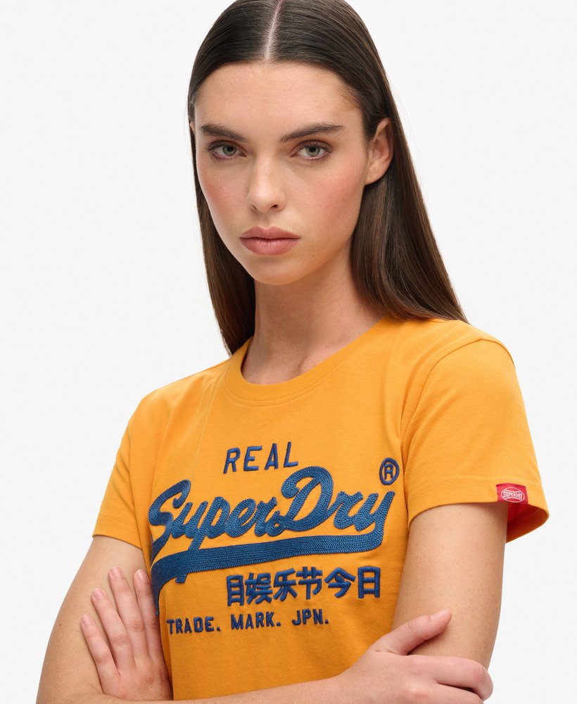 getailleerd t-shirt met geborduurd vintage logo in track gold